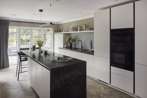 Special matt lacquer cabinetry with a marble-effect Caesarstone worksurface in a Chislehurst kitchen.