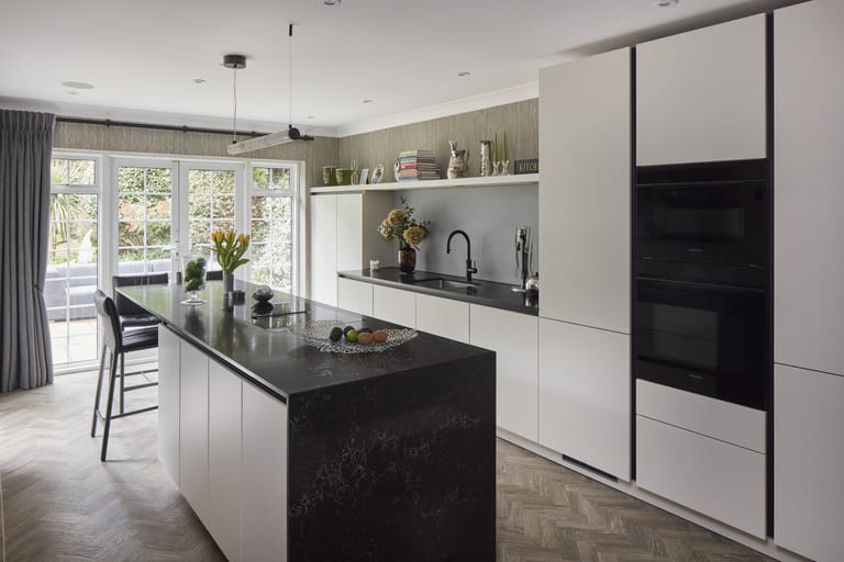 Special matt lacquer cabinetry with a marble-effect Caesarstone worksurface in a Chislehurst kitchen.
