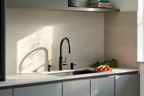 Fenix Taupe cabinetry with a concrete-effect Caesarstone worksurface in a Purley kitchen.