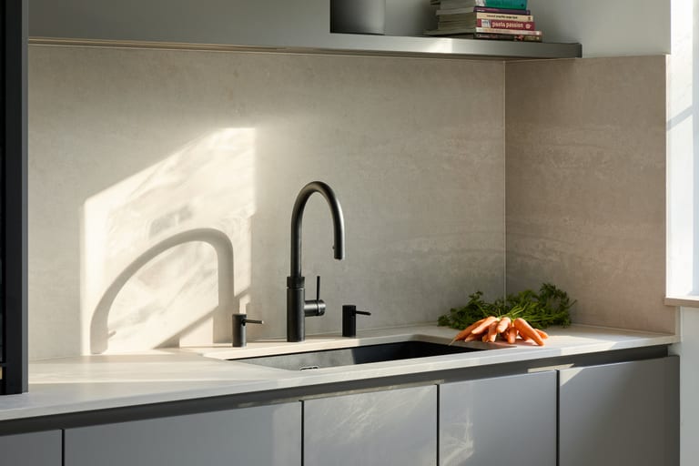 Fenix Taupe cabinetry with a concrete-effect Caesarstone worksurface in a Purley kitchen.