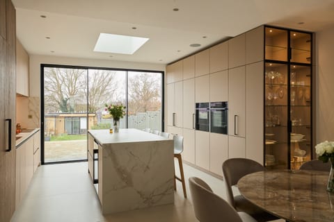 Fenix Taupe cabinetry with a marble-effect Dekton worksurface in a Chessington kitchen.