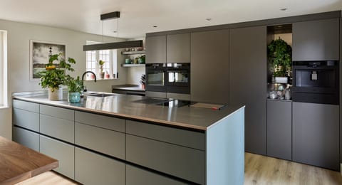 Hever Colour & Stainless Steel Kitchen — wide view of the peninsula and cabinetry wall.