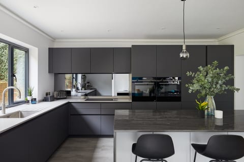 Super-matt white and anthracite cabinetry with Sense and Silestone worksurfaces in a Coney Hall kitchen.